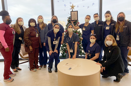 Staff from the hematology/oncology/bone marrow transplant nursing team pose with the Team Daisy Award